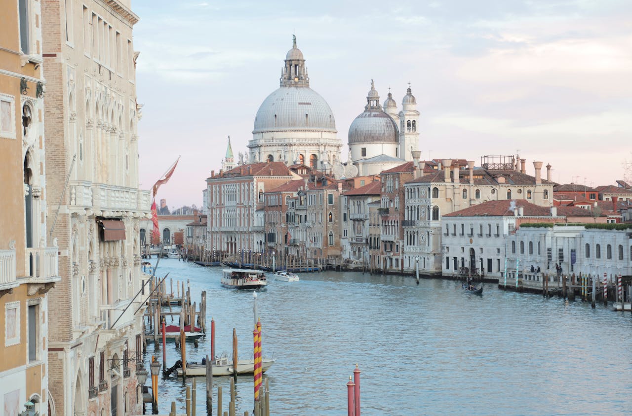 View of grand canal and old cathedral of Santa Maria della Salute in Venice in Italy on early calm morning